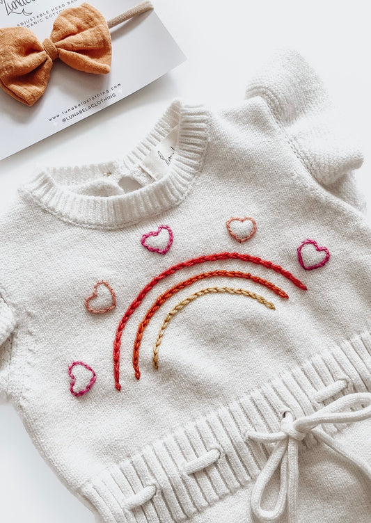 Barboteuse en tricot arc-en-ciel